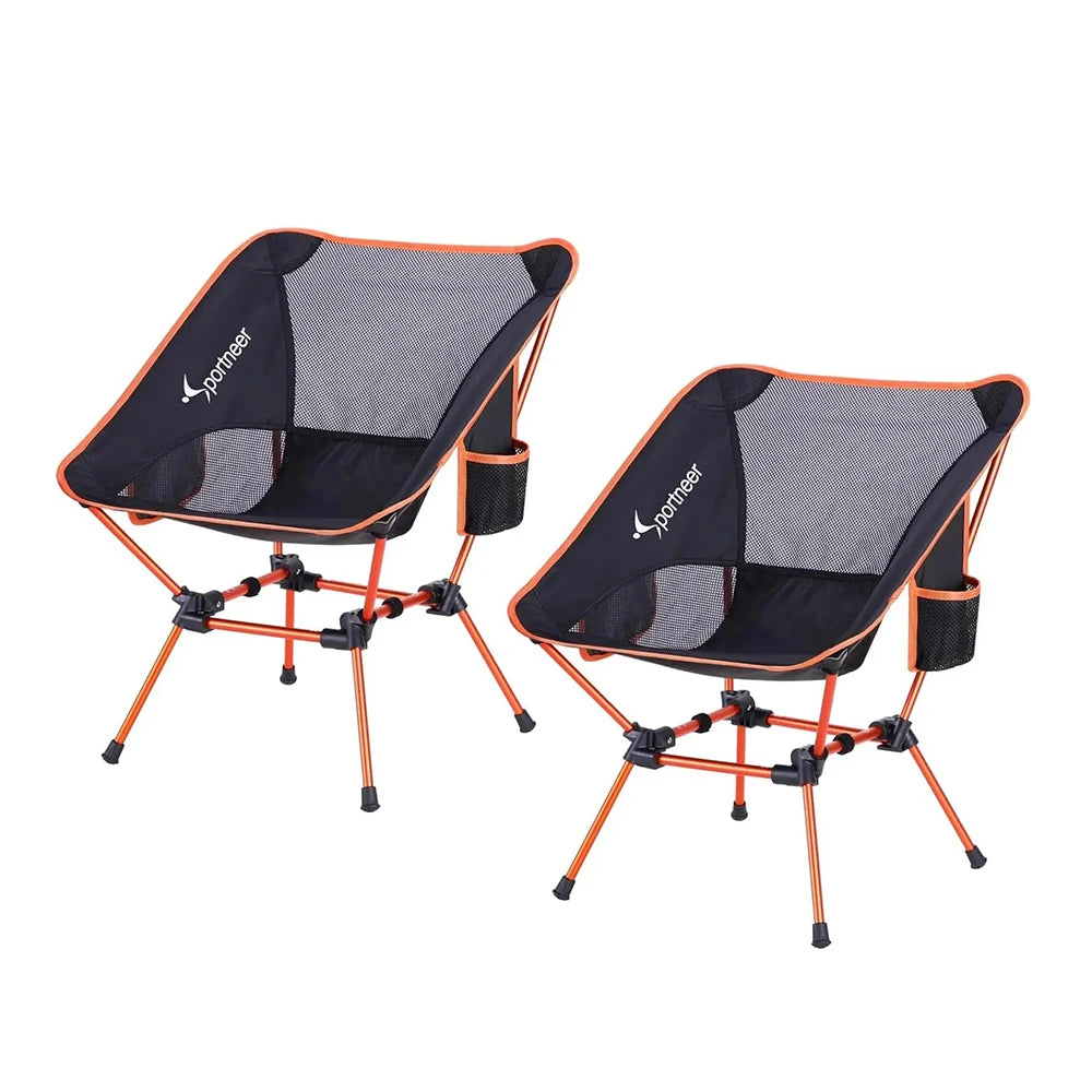 a couple of chairs and a black umbrella