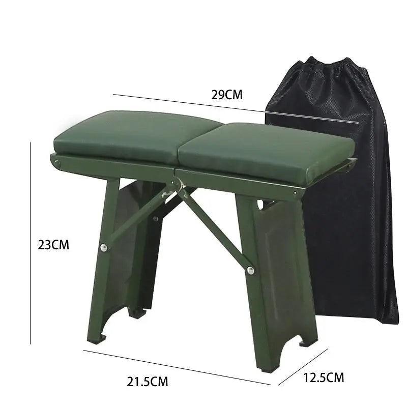 a green piece of luggage sitting on top of a suitcase