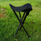 a black bird is sitting in a green chair