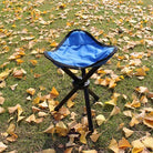 a blue umbrella sitting on top of a patch of grass