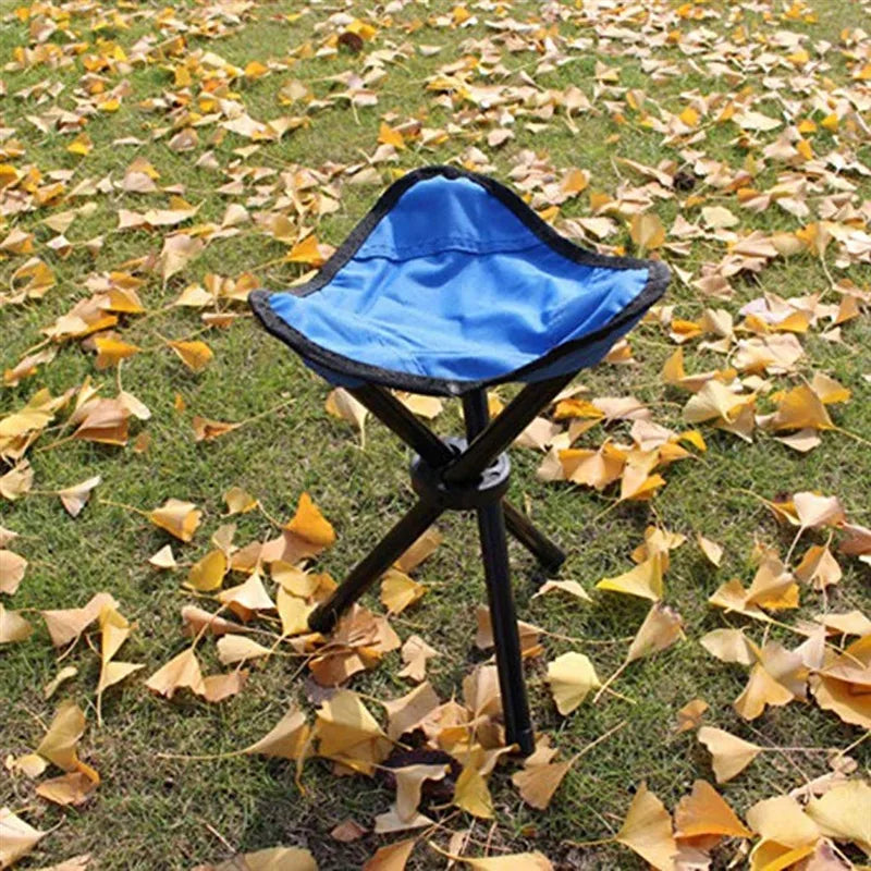a blue umbrella sitting on top of a patch of grass