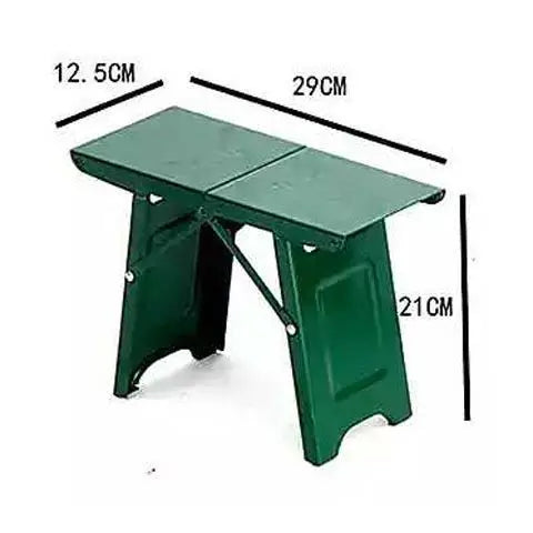 a green umbrella is sitting in the snow