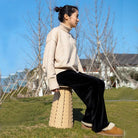 a man sitting on a bench in a park