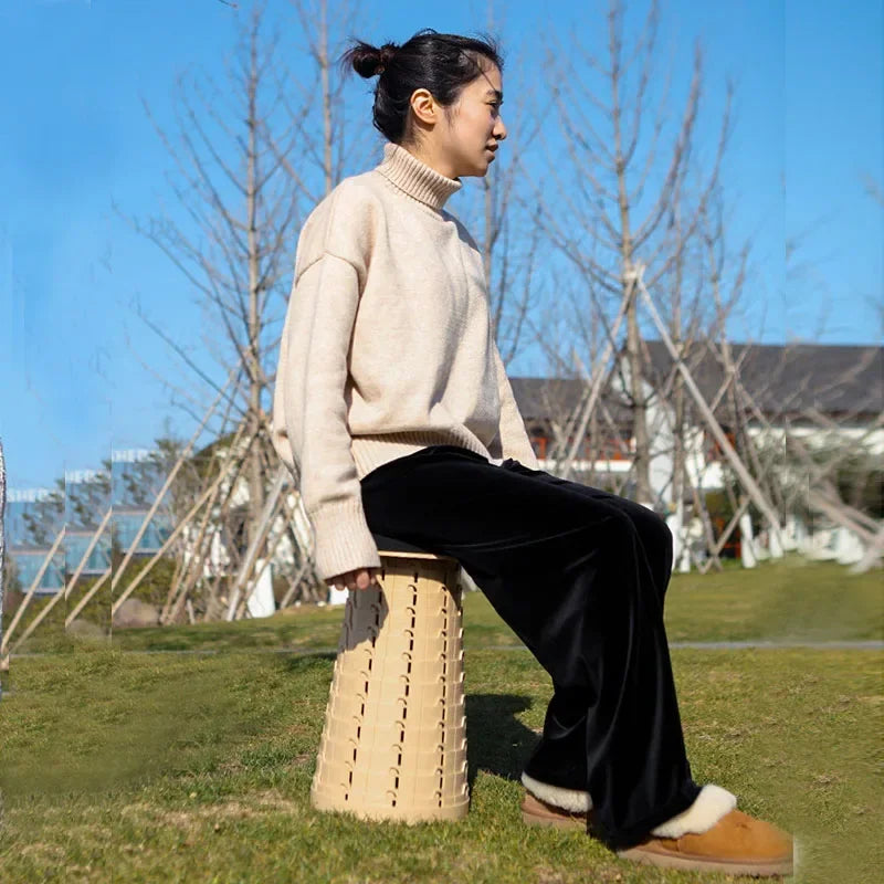 a man sitting on a bench in a park
