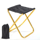 a black and yellow umbrella on a white surface