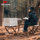a man sitting on a bench in a park