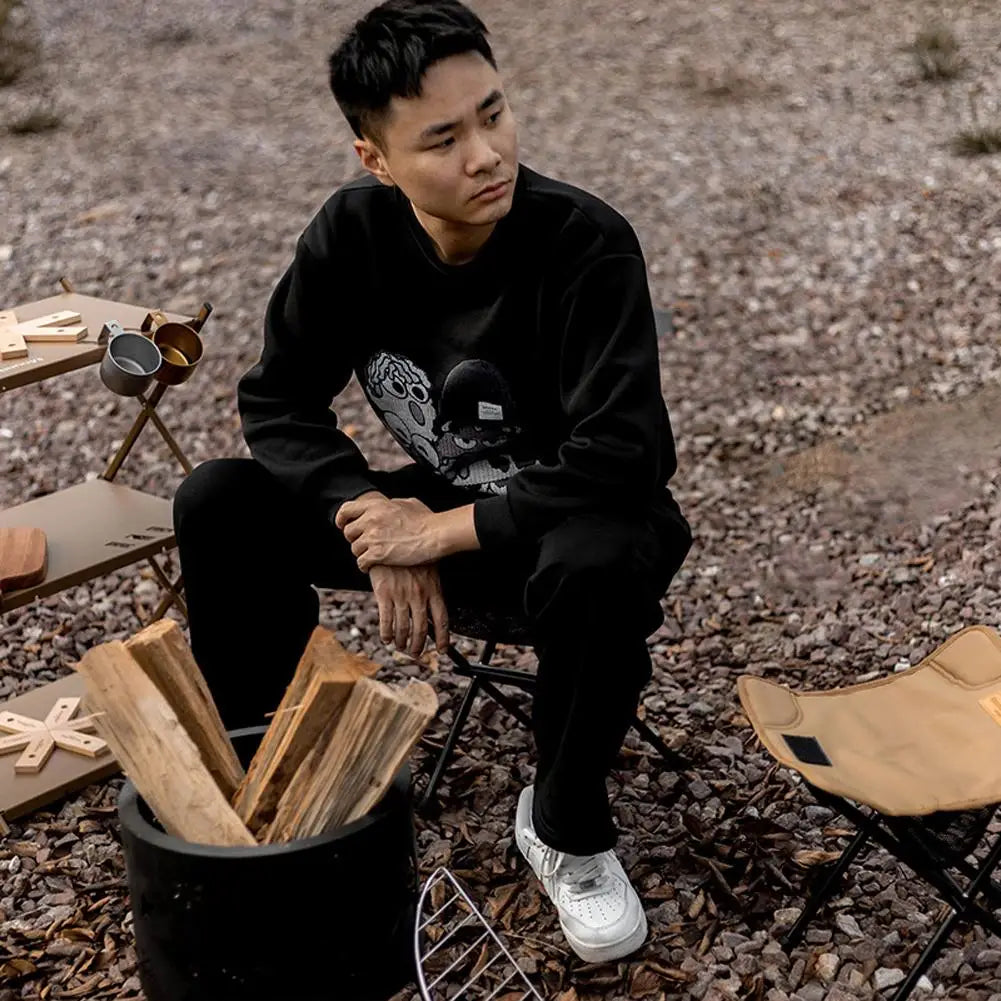 a man is sitting on a wooden bench 