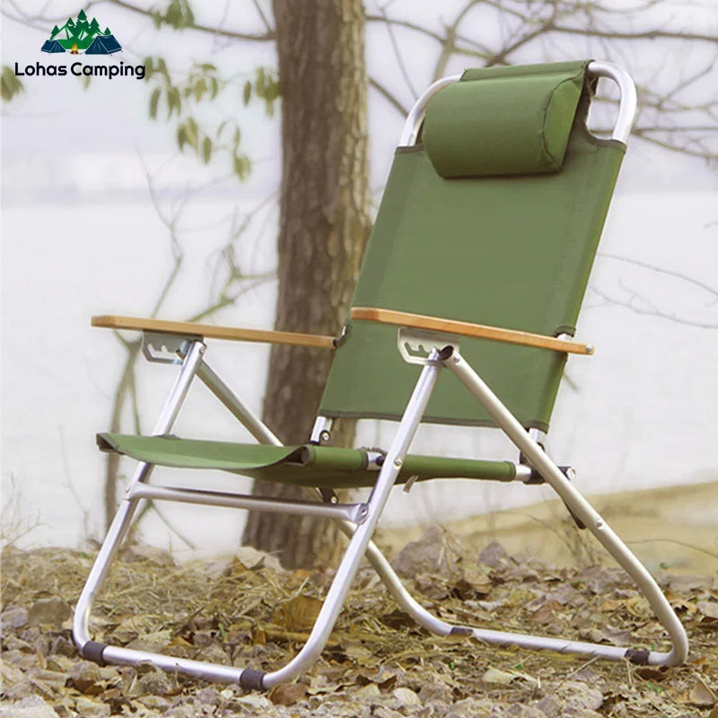 a green lawn chair sitting in the grass 