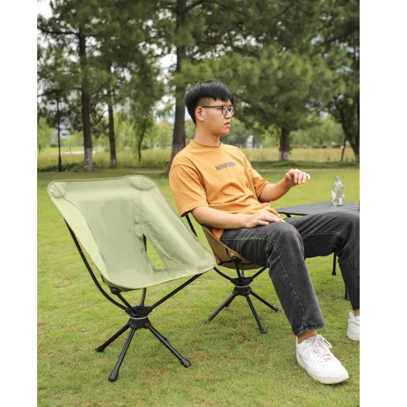 a man sitting on a bench using a laptop 