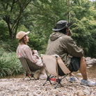 a couple of people that are sitting in the dirt 