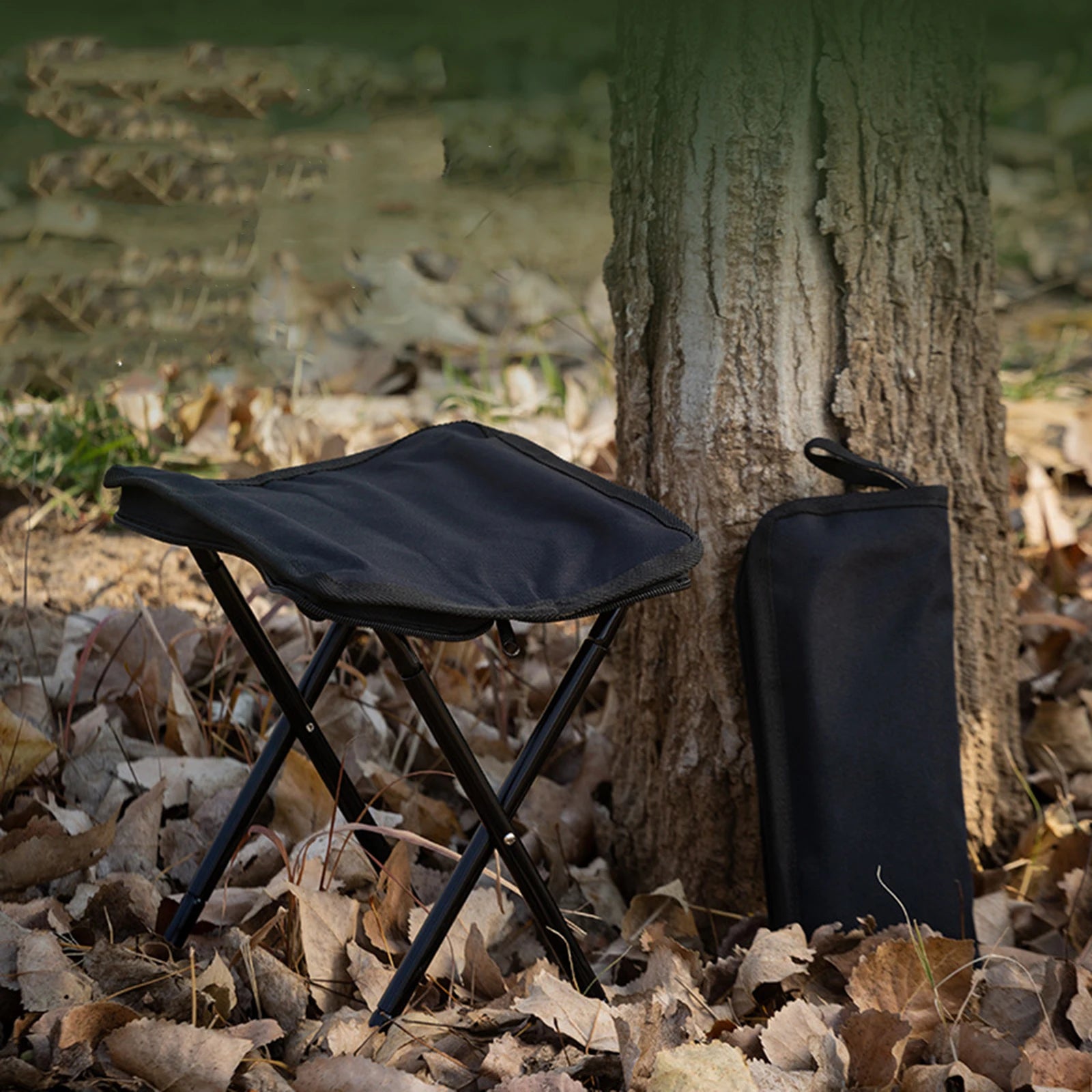 a black umbrella sitting in the middle of a forest 