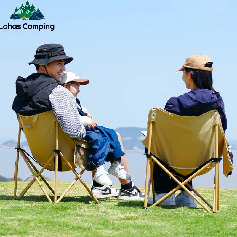 a man and a woman sitting on a lawn chair 