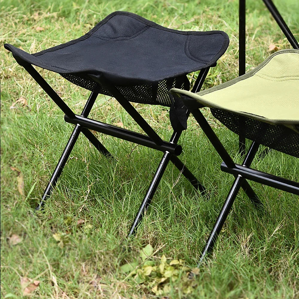 a black umbrella sitting on top of a lawn chair 