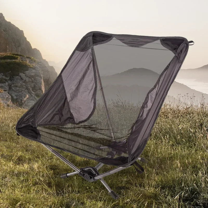 a small black and white umbrella sitting in the grass 